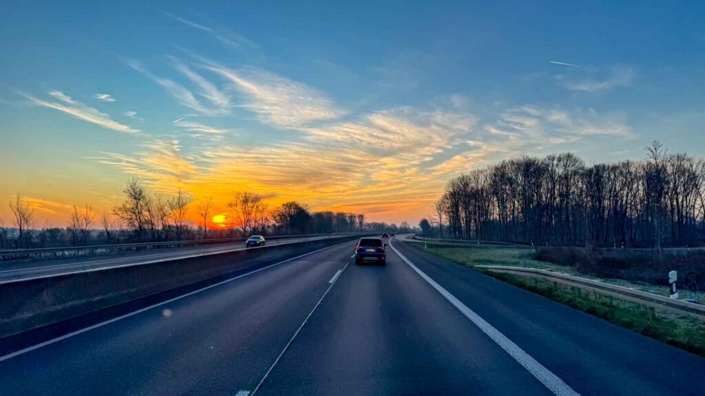 Oranje zonsopkomst boven de Duitse autobahn onderweg naar Oostenrijk